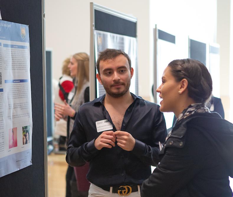 Photo of student presenting poster 